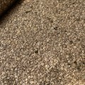 Tapeta z naturalnej miki z widoczną strukturą drobnych płatków mineralnych. Zbliżenie pokazuje naturalny połysk, nieregularną powierzchnię oraz warstwową budowę dekoracyjnej okładziny ściennej.